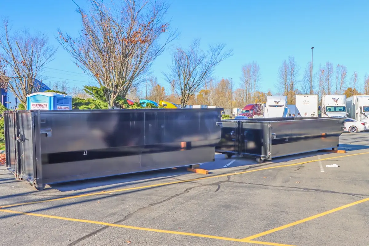 Professional dumpster rental service with roll-off container on residential driveway in Burnsville